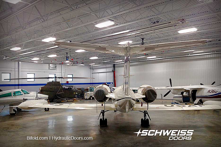 Aviation High School has hangar with Schweiss Door with various aircraft
