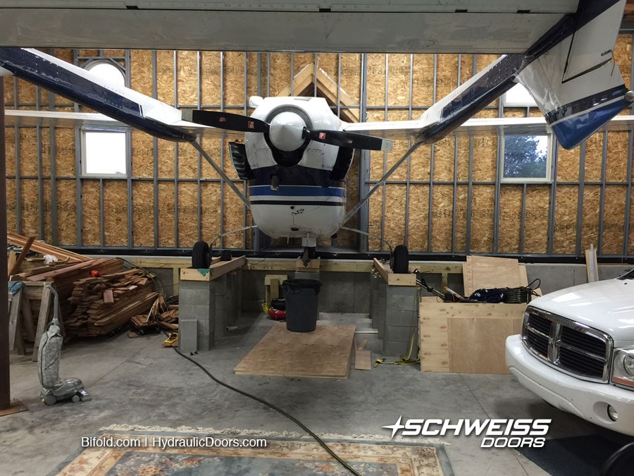 Airplane inside hangar is elevated to roll through Schweiss Doors